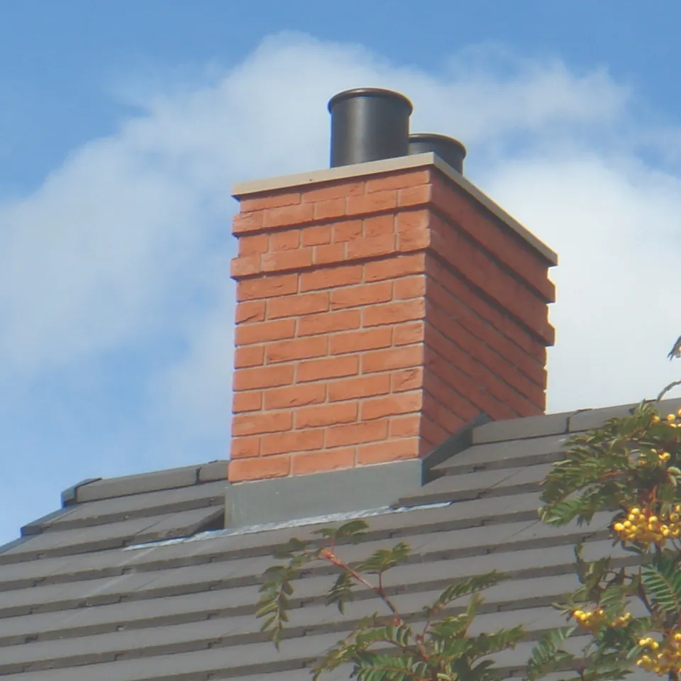 Brick chimney stack with new flashing and cowls