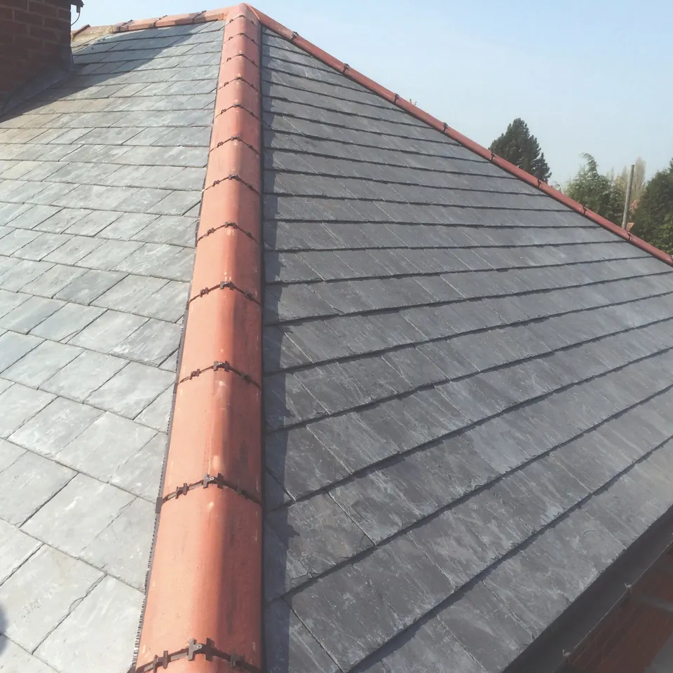New slate roof finished with terracotta ridge tiles