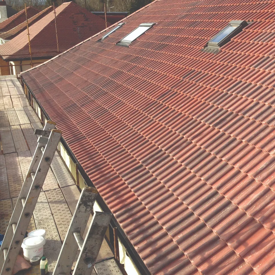 Re-tiled roof with roof windows seen from the scaffold